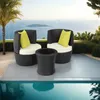 A rattan seating set with cushions and a table is placed on a patio next to a swimming pool, with a view of the ocean and an island in the background. Voir les images du produit