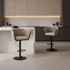 A modern kitchen with two beige bar stools in the foreground. Anteprima dell’immagine prodotto