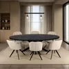 A dining room setting with an oval table and chairs. Voir les images du produit