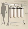 A diagram illustrating the dimensions of a portable garment rack with punching bags, alongside a silhouette of a person for scale. Náhled obrázku produktu