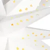 A close-up view of a white paper star decoration with small gold stars cut out or applied to its surface. Podgląd zdjęcia produktu