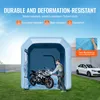 A person is putting a motorcycle into an inflatable paint booth, with a car parked nearby. Náhľad obrázku produktu
