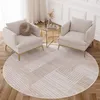 Two cream armchairs are placed on a round rug with a geometric pattern in a living room setting. Produktbild-Vorschau