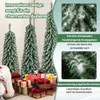 Three artificial Christmas trees with snow-like flocking, surrounded by gift boxes and a teddy bear. Podgląd zdjęcia produktu