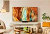 A modern living room with a large TV on a stand, a sofa, and a coffee table. Voir les images du produit