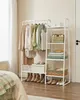 A white clothing rack with clothes and accessories displayed in a room. Náhled obrázku produktu