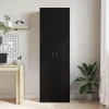 A tall, black, two-door cabinet is shown in a room with a desk and a plant. Voir les images du produit