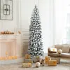 A festive living room scene with a flocked Christmas tree, presents, and a fireplace. Produktbild-Vorschau