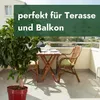 A balcony setting with a small table and chairs, a potted plant, and a view of buildings in the background. Produktbild-Vorschau