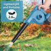 A person is holding a blue leaf blower in an outdoor setting with autumn leaves on the ground. Podgląd zdjęcia produktu