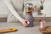 A person is using a stand mixer to make a smoothie in a kitchen setting. Náhľad obrázku produktu