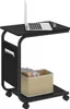 A black rolling side table with a laptop on top and a basket of books on the lower shelf. Náhľad obrázku produktu