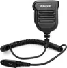 A black microphone with a coiled cable and a connector is shown against a white background. Náhled obrázku produktu