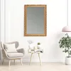 A living room scene with a mirror, armchair, side table, and plant. Produktbild-Vorschau