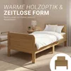 A bedroom scene with a wooden bed and bedding, featuring marketing text. Produktbild-Vorschau