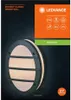 The image shows the packaging of an outdoor wall lamp, with the product itself partially visible. Voir les images du produit