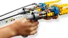 A child's hand holding a LEGO Star Wars Anakin's Podracer. Produktbild-Vorschau