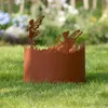 A rusty metal garden border with fairy silhouettes, placed on a grassy lawn with blurred flowers in the background. Produktbild-Vorschau