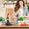 A woman is preparing food in a kitchen while a cordless phone sits on the counter. Náhled obrázku produktu