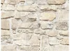 A close-up view of a stone wall texture. Produktbild-Vorschau