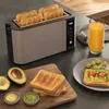 A toaster with toast and avocado toast on a counter. Anteprima dell’immagine prodotto