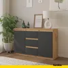 A modern sideboard with dark gray doors and wood accents, placed in a living room setting with a plant and artwork. Voir les images du produit