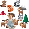 A baby sitting among felt woodland animal crafts. Produktbild-Vorschau