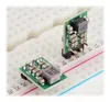 Two small electronic components are placed on a white breadboard. Produktbild-Vorschau