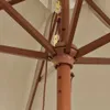 A close-up view of the central mechanism of an open umbrella, showing the wooden pole, spokes, and pulley system. Náhľad obrázku produktu