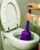A person is using a purple plunger in a white toilet. Produktbild-Vorschau
