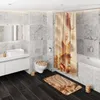 A modern bathroom with marble tiles, a toilet, a sink, a bathtub, and a shower curtain with a seashell print. Produktbild-Vorschau