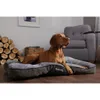 A dog is lying on a dog bed in a living room setting. Anteprima dell’immagine prodotto