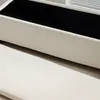 A close-up view of a beige corduroy storage bench with a black interior. Podgląd zdjęcia produktu