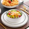 A table setting with a bowl of salad and a bowl of pasta. Produktbild-Vorschau
