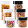 A collection of six clear plastic food storage containers with different colored lids, filled with various food items. Produktbild-Vorschau