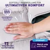 A hand is pressing down on a soft, gray blanket, illustrating its comfort and texture. Arrows indicate breathability. Produktbild-Vorschau