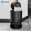 A person is placing a dust bag into an automatic dust collection station for a robot vacuum cleaner. Voir les images du produit