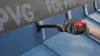 A gloved hand is using a tool to crimp a metal seam on a blue roof. Náhľad obrázku produktu