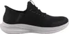 A side view of a black Skechers slip-on sneaker with a white sole. Anteprima dell’immagine prodotto
