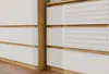 A close-up view of a modern dresser or cabinet with white drawers and a wooden frame. Anteprima dell’immagine prodotto