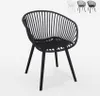 A black modern chair with armrests is shown against a white background. In the background, there are three other chairs in white, gray, and black. Produktbild-Vorschau