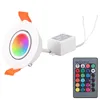 A white LED recessed light with a multicolor light display, a white control box, and a remote control are shown against a white background. Produktbild-Vorschau