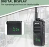 A walkie-talkie with a digital display, set against a blurred industrial background. Produktbild-Vorschau