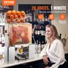 A commercial orange juicer is shown in a bar setting with a woman sitting at the counter. Anteprima dell’immagine prodotto