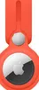 A close-up view of an orange Apple AirTag loop case with the AirTag inserted. Podgląd zdjęcia produktu