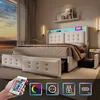 A bedroom scene featuring a bed with LED lighting and storage drawers, with a remote control and feature icons in the foreground. Produktbild-Vorschau