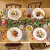 A beautifully set dining table for a festive occasion, likely Christmas, with plates, cutlery, a candle, and a garland. Anteprima dell’immagine prodotto
