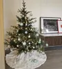 A decorated Christmas tree with a tree skirt. Anteprima dell’immagine prodotto