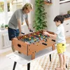 A father and son are playing foosball in a bright, well-lit room. Produktbild-Vorschau