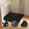 A modern black shower tray with a stone-like texture is shown in a bathroom setting, with close-up insets highlighting its features. Anteprima dell’immagine prodotto